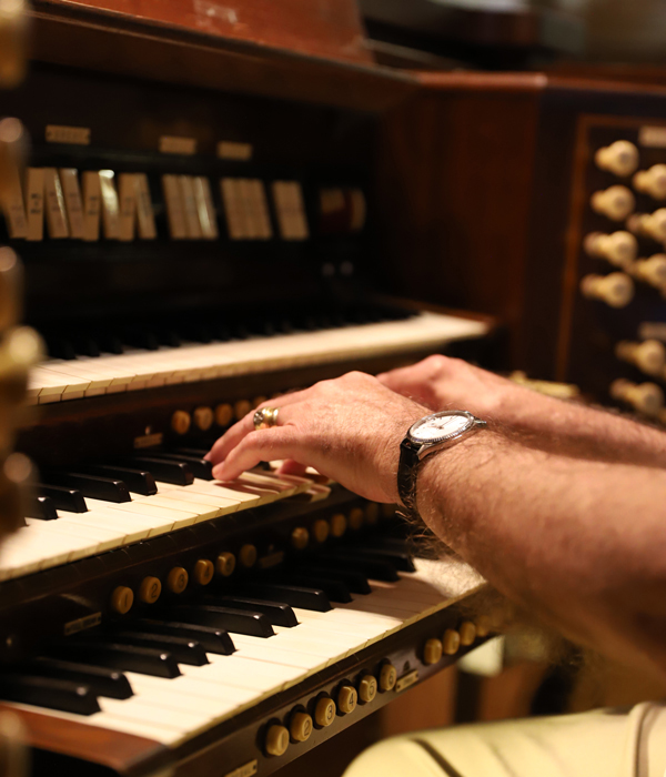close-up of hands playing an organ